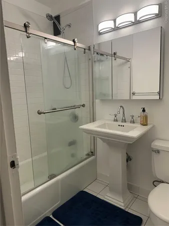 a bathroom with a toilet a sink and mirror