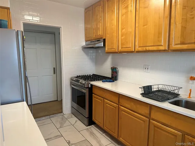 a kitchen with stainless steel appliances granite countertop a stove a sink and dishwasher