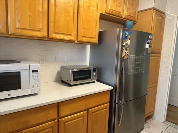 a kitchen with a refrigerator stove and cabinets