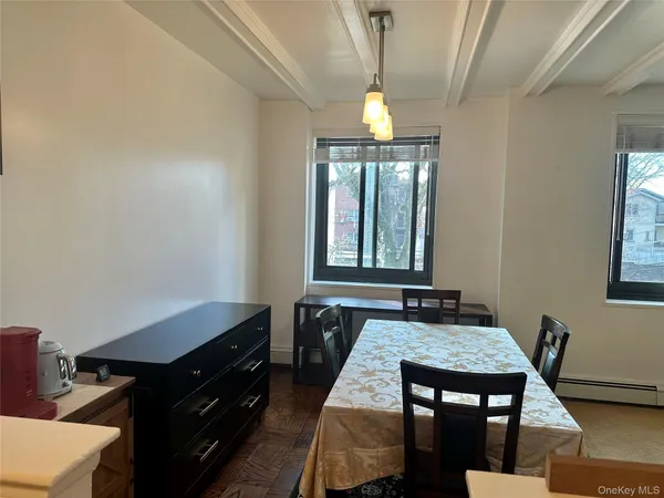a dining room with wooden floor and a window