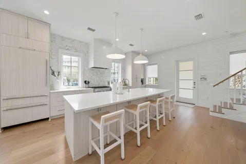 a large kitchen with a table and chairs