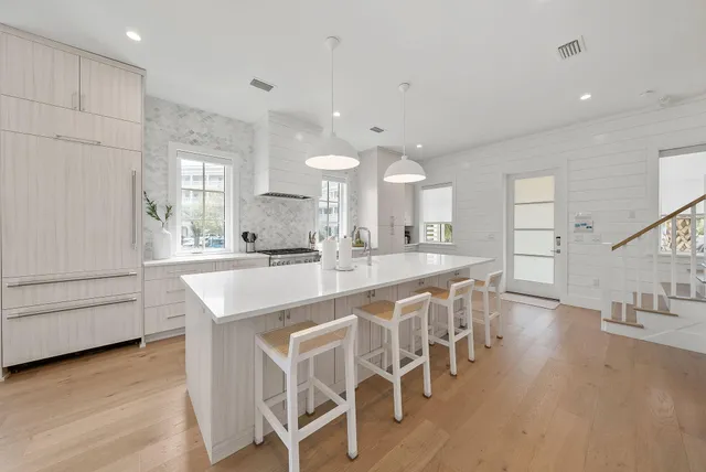 a large kitchen with a table and chairs