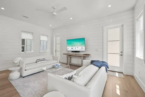 a view of a hallway with wooden floor and entryway