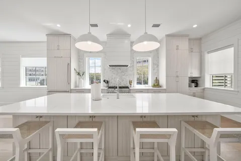 a bathroom with double sink and a shower