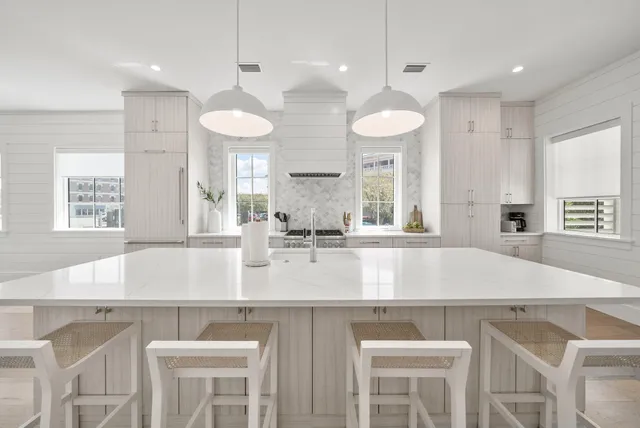 a bathroom with double sink and a shower