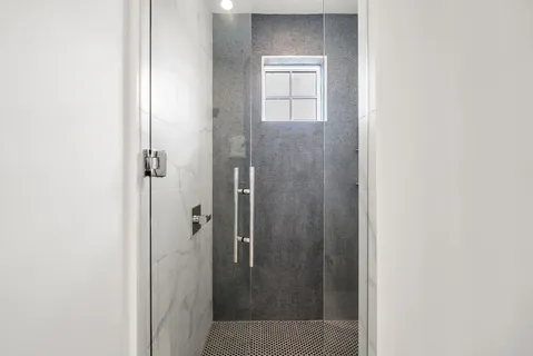 a bedroom with a bed and a flat tv screen on dresser