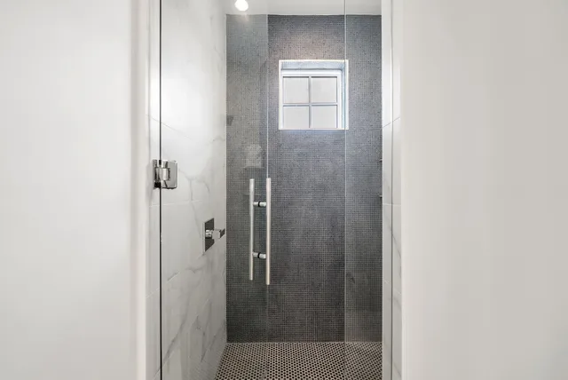 a bedroom with a bed and a flat tv screen on dresser