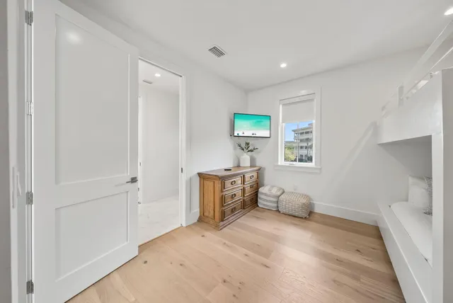 a bedroom with a bed and a painting on the wall