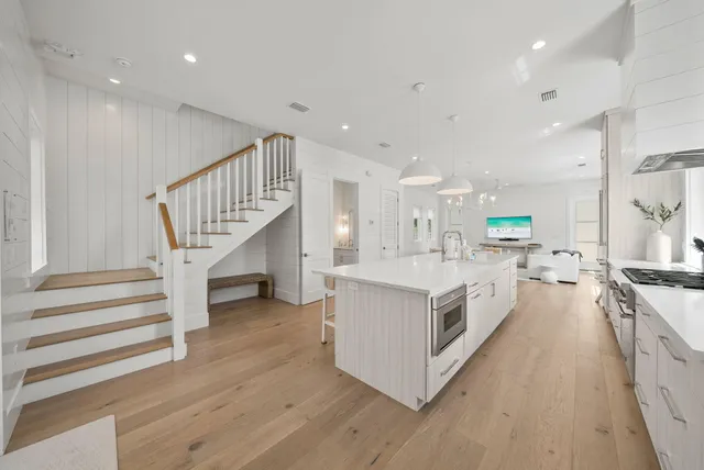 a dining room with kitchen island furniture a large window and appliances