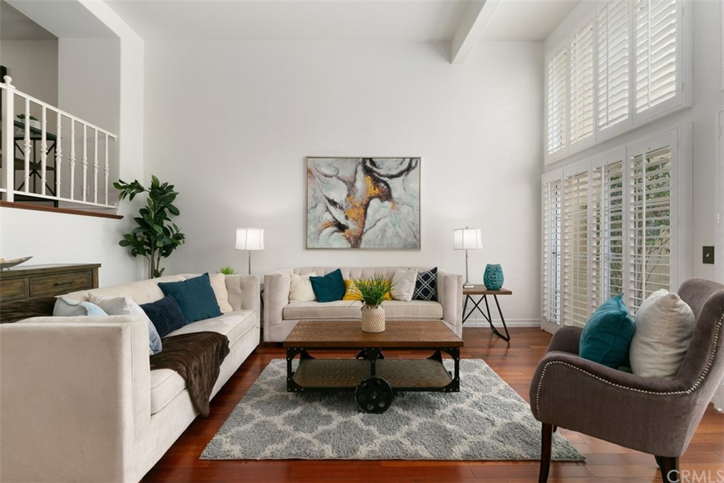 6051 Shadowbrook Circle Huntington Beach, CA 92648 - Photo 1 of 42 a living room with furniture and a potted plant
