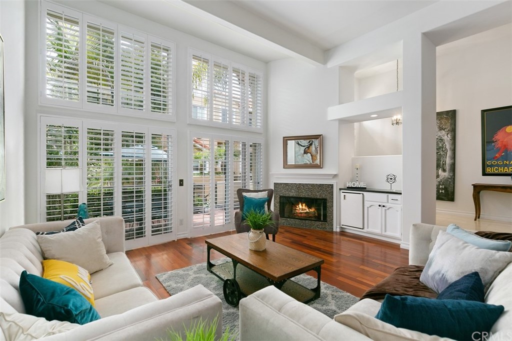 6051 Shadowbrook Circle Huntington Beach, CA 92648 - Photo 11 of 42 a living room with furniture fireplace and a large window