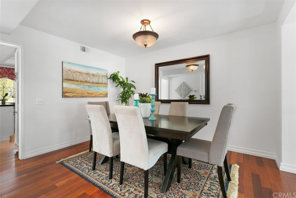 6051 Shadowbrook Circle Huntington Beach, CA 92648 - Photo 13 of 42 a view of a dining room with furniture window and wooden floor