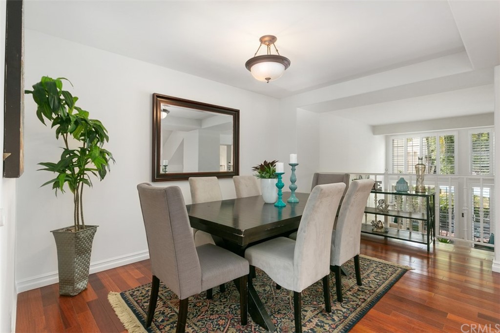 6051 Shadowbrook Circle Huntington Beach, CA 92648 - Photo 14 of 42 a view of a dining room with furniture window and wooden floor