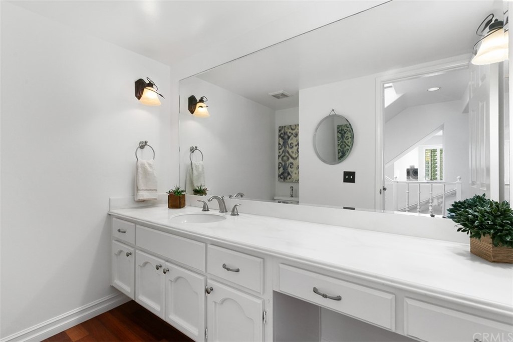 6051 Shadowbrook Circle Huntington Beach, CA 92648 - Photo 16 of 42 a bathroom with a sink and a mirror