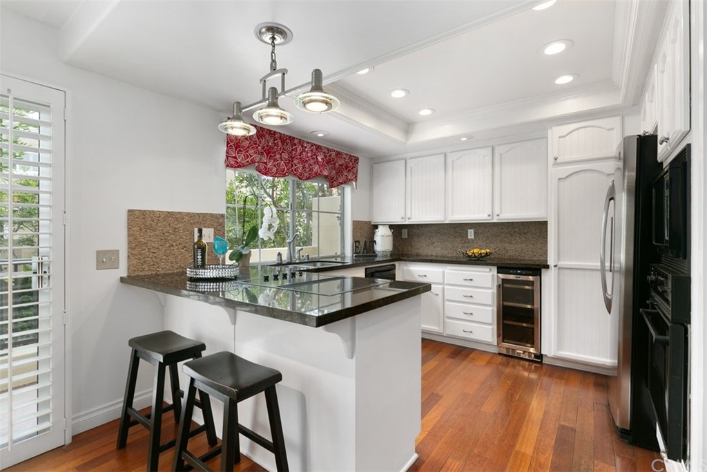 6051 Shadowbrook Circle Huntington Beach, CA 92648 - Photo 19 of 42 a kitchen with stainless steel appliances granite countertop a stove refrigerator sink and microwave