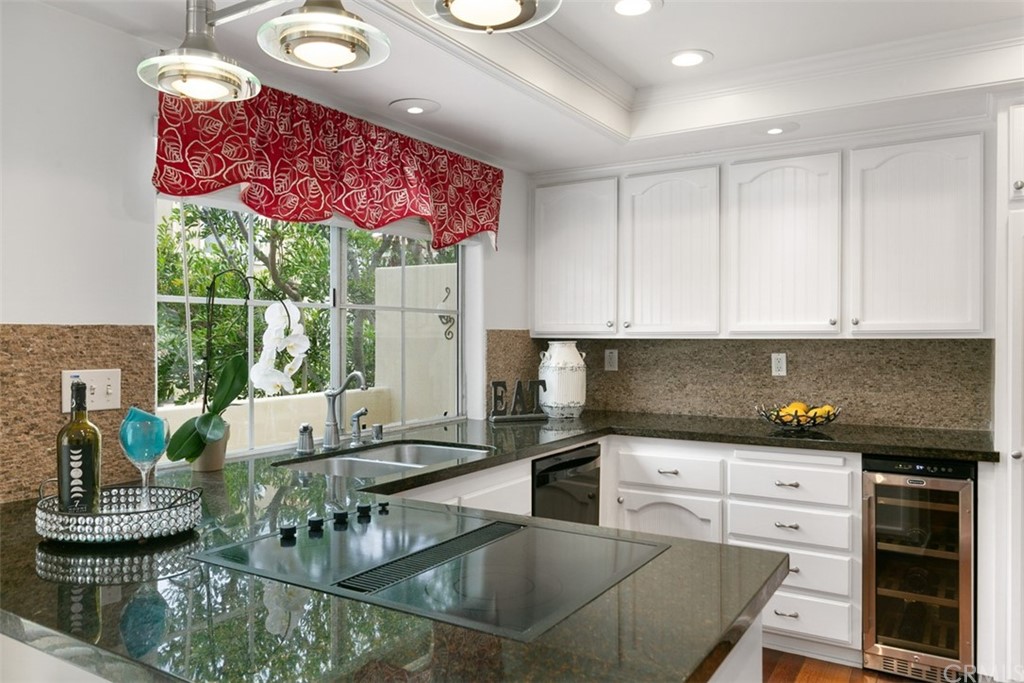6051 Shadowbrook Circle Huntington Beach, CA 92648 - Photo 20 of 42 a kitchen with stainless steel appliances granite countertop a stove a sink and a granite counter tops with white cabinets