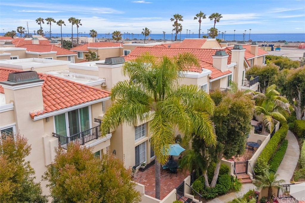 6051 Shadowbrook Circle Huntington Beach, CA 92648 - Photo 2 of 42 a view of a swimming pool with outdoor seating and plants