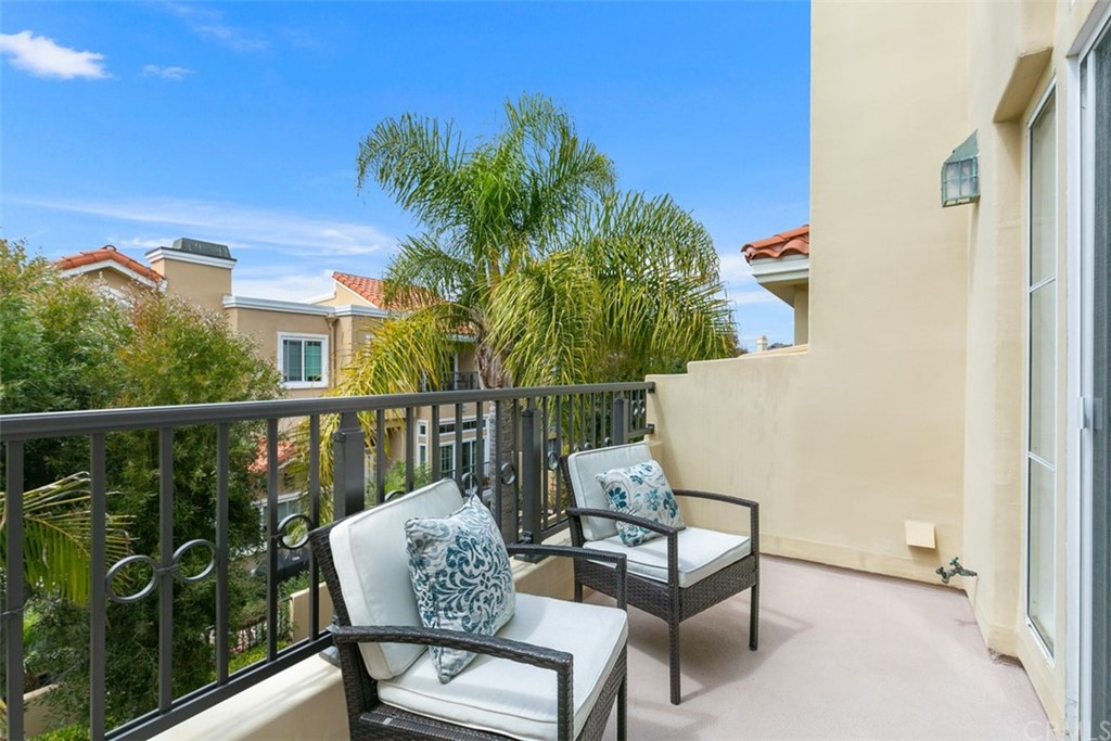 6051 Shadowbrook Circle Huntington Beach, CA 92648 - Photo 27 of 42 a view of a chair and table in the balcony
