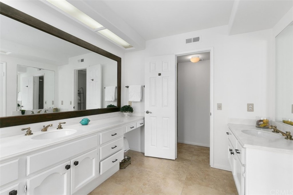 6051 Shadowbrook Circle Huntington Beach, CA 92648 - Photo 29 of 42 a bathroom with a double vanity sink mirror and double