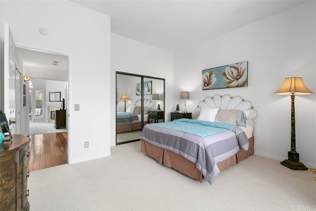 6051 Shadowbrook Circle Huntington Beach, CA 92648 - Photo 31 of 42 a bedroom with a bed and lamp