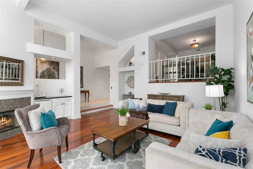 6051 Shadowbrook Circle Huntington Beach, CA 92648 - Photo 10 of 42 a living room with furniture and a painting on the wall