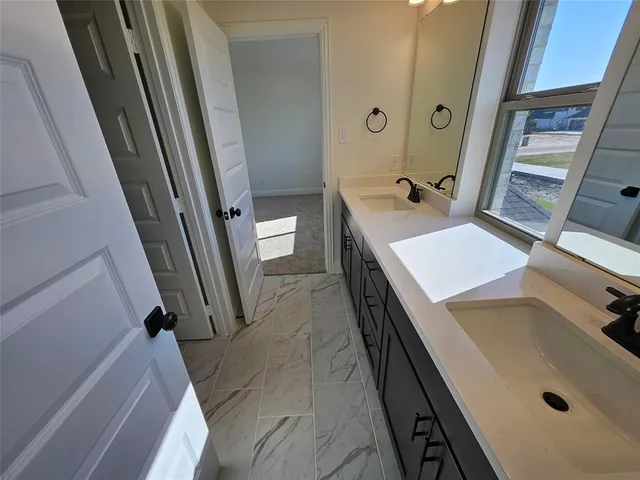 a bathroom with a sink a mirror and a toilet