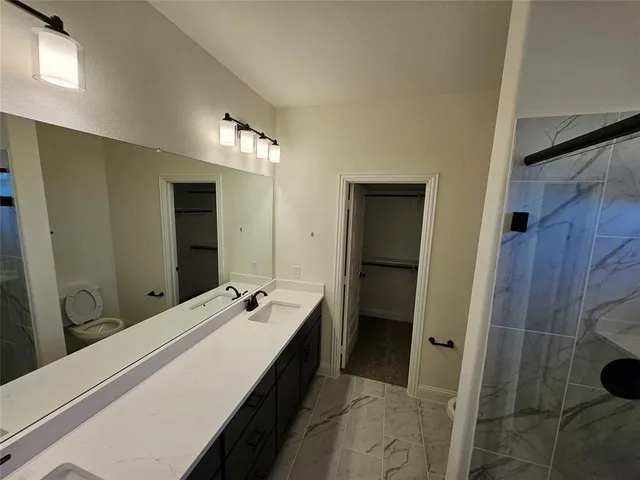 a bathroom with a double vanity sink and mirror