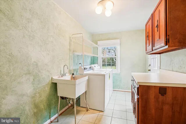 a view of a kitchen with a sink and a refrigerator
