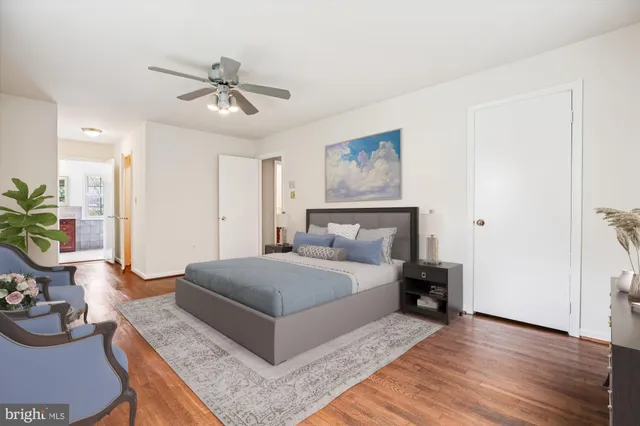 a bedroom with a bed and ceiling fan