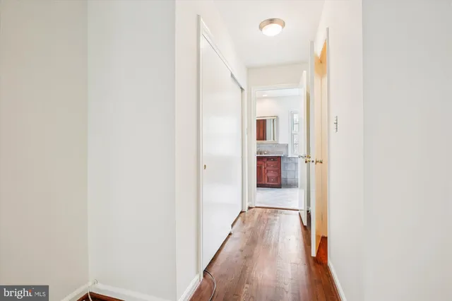 a view of a hallway with wooden floor