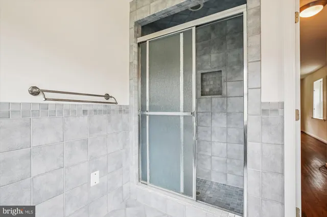 a bathroom with a glass shower door
