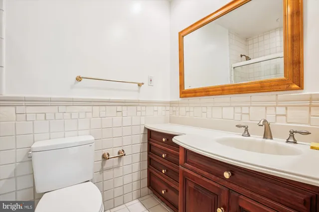 a bathroom with a sink mirror vanity and toilet
