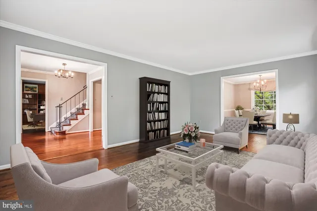 a living room with furniture a rug and a large window