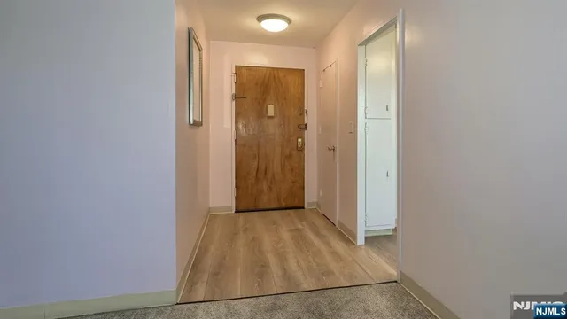 a kitchen with stainless steel appliances granite countertop a stove a refrigerator and a white cabinets