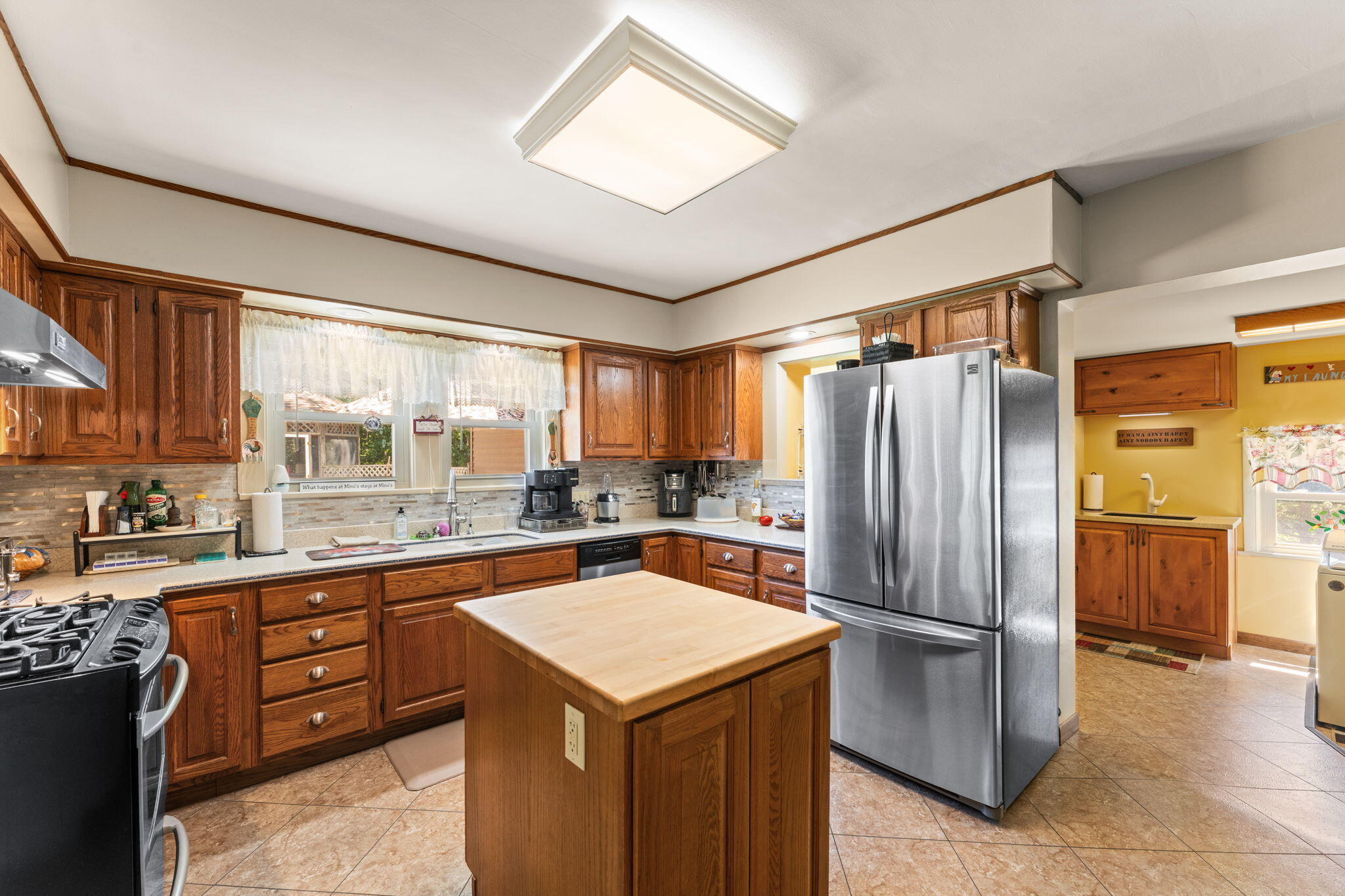 138 McClung Road La Porte, IN 46350 - Photo 10 of 50 a kitchen with a refrigerator a sink dishwasher and wooden cabinets