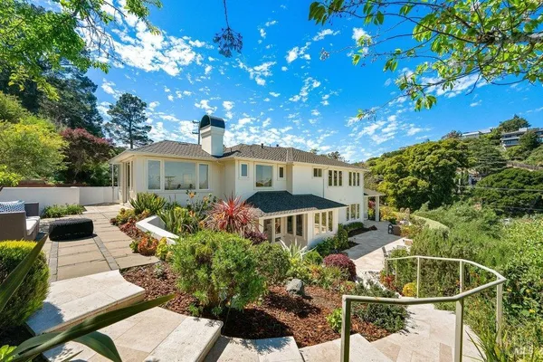 a front view of a house with garden