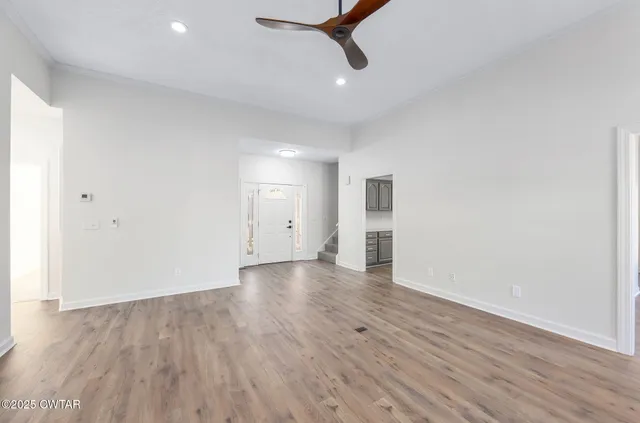 wooden floor in an empty room with a window