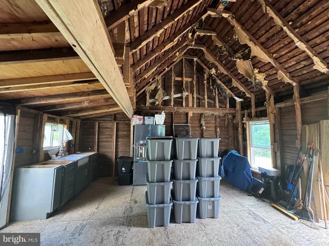 a bedroom with a bed and a wooden floor