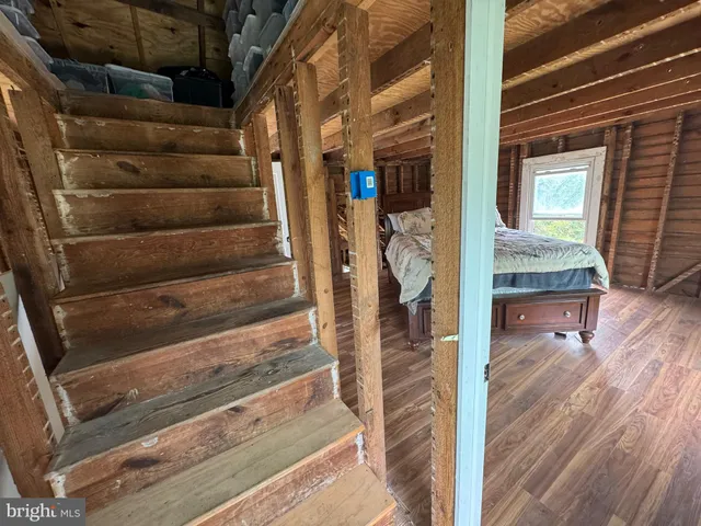 a view of a house with a big yard and large trees