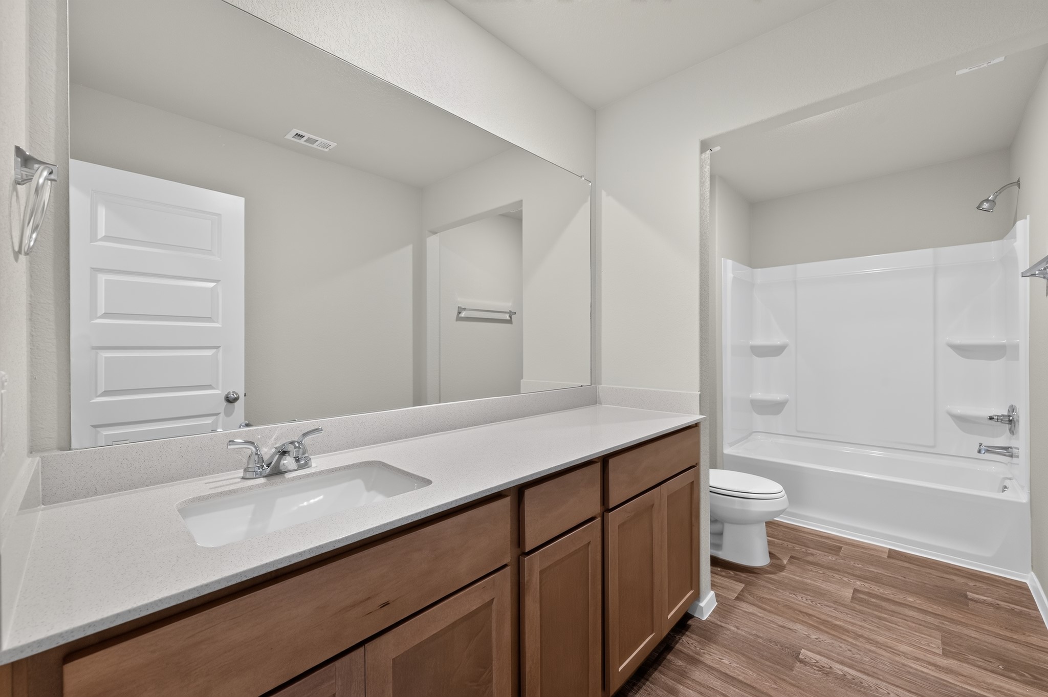 2704 Towy Road Manor, TX 78653 - Photo 19 of 36 Sleek vanity surfaces and clean transitions define this functional modern bathroom space.