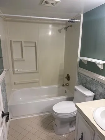 a bathroom with a toilet a sink and bathtub
