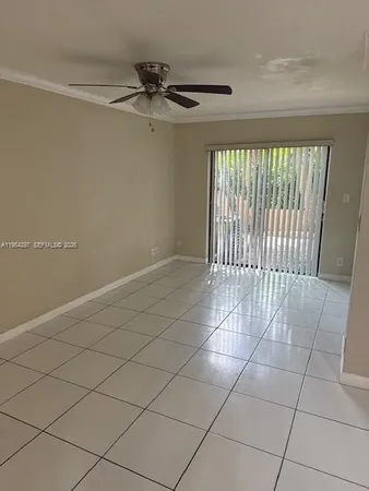 a view of a livingroom with a large window dryer and staircase