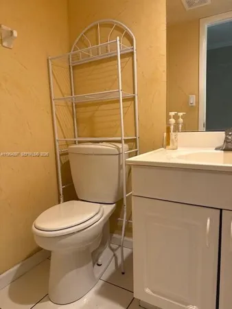 a white toilet sitting next to a bathroom sink