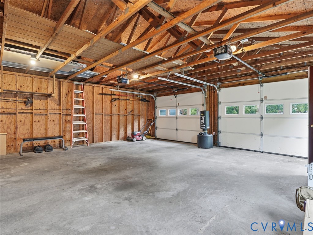 7707 Woodbrook Road Quinton, VA 23141 - Photo 38 of 42 Spacious garage featuring exposed wood beam ceilin
