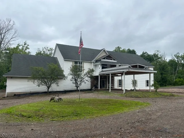 a front view of a house with a garden and yard