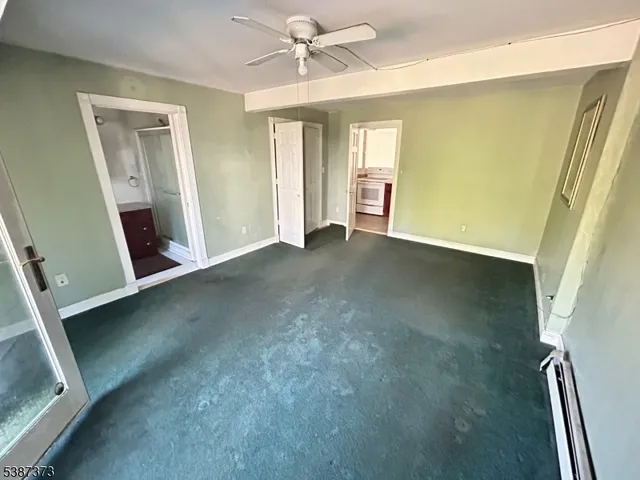 a view of an empty room with a fireplace