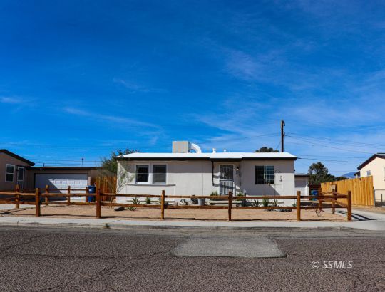 313 North Florence Street Ridgecrest, CA 93555 - Photo 3 of 38 a front view of a house with a yard
