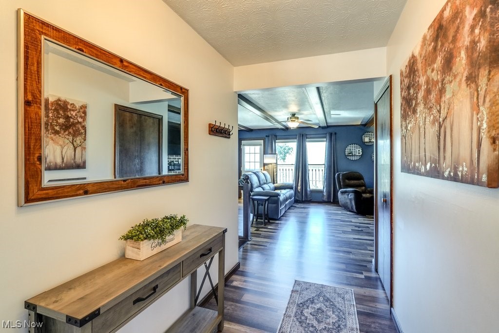 1157 Bass Circle Northwest Canton, OH 44708 - Photo 2 of 31 Corridor with a textured ceiling and dark wood finished floors