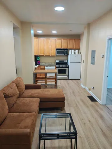 a room with furniture and a view of kitchen