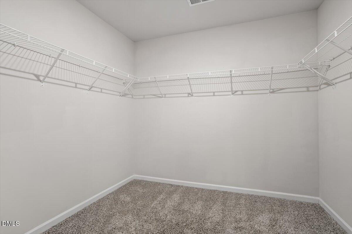 46 Coffee Tree Circle Clayton, NC 27527 - Photo 26 of 36 a view of a room with racks on the wall